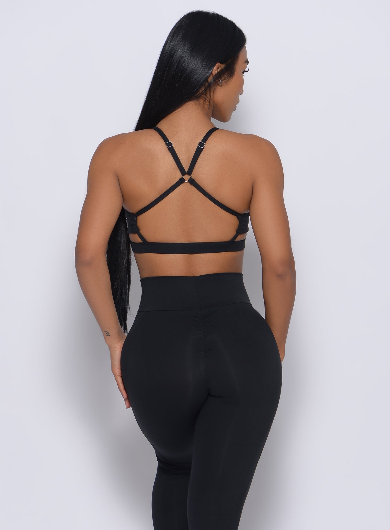 Strappy black Pumped Sports Bra with a high-impact, open-back design for intense gym workouts.