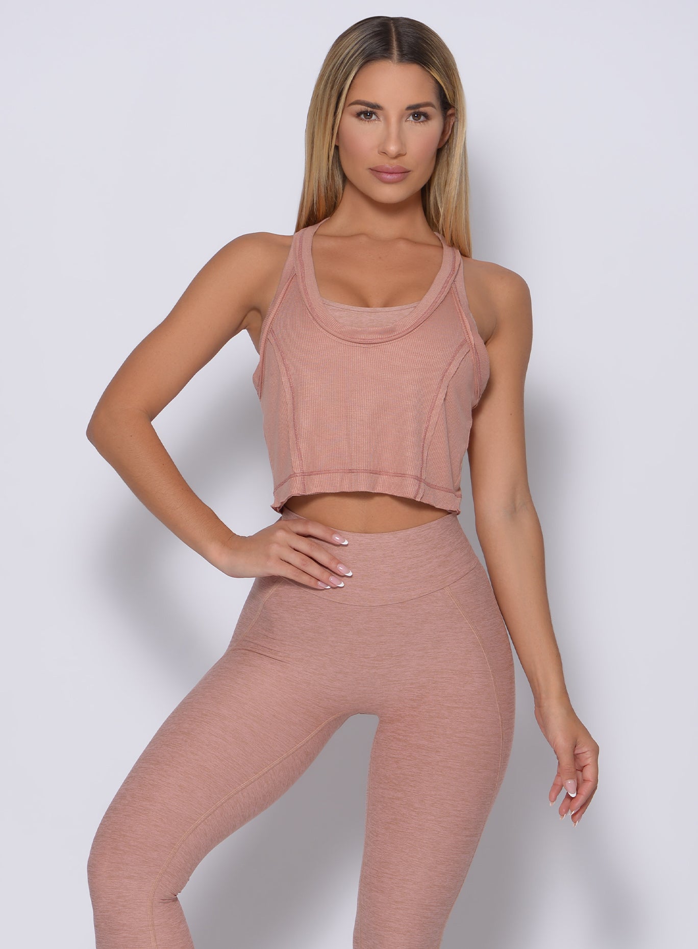 Model facing forward wearing our rib crop tank in frappe color and a matching leggings