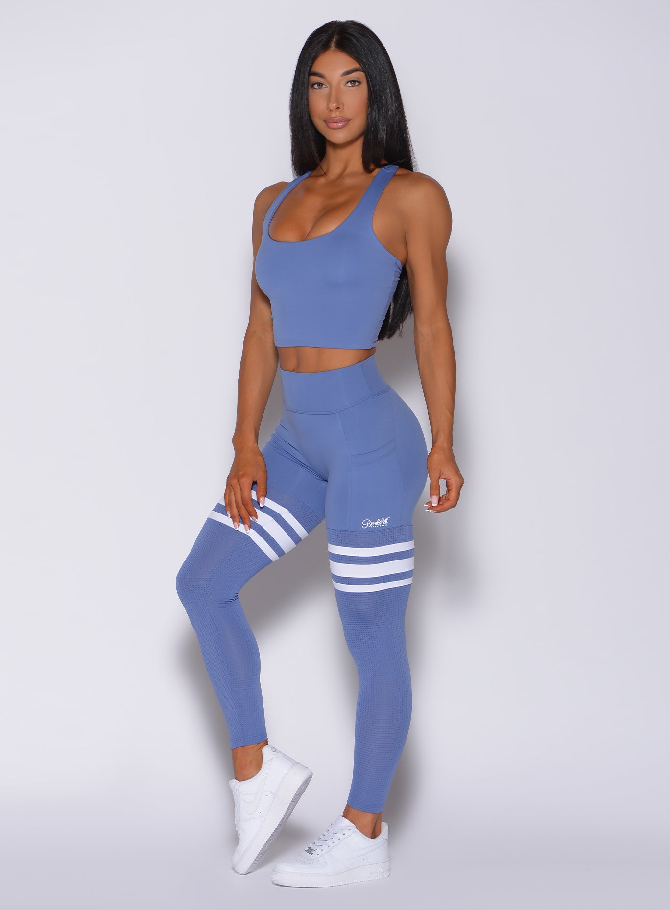 Front profile view of a model wearing our scrunch thigh high in denim blue color and a matching bra