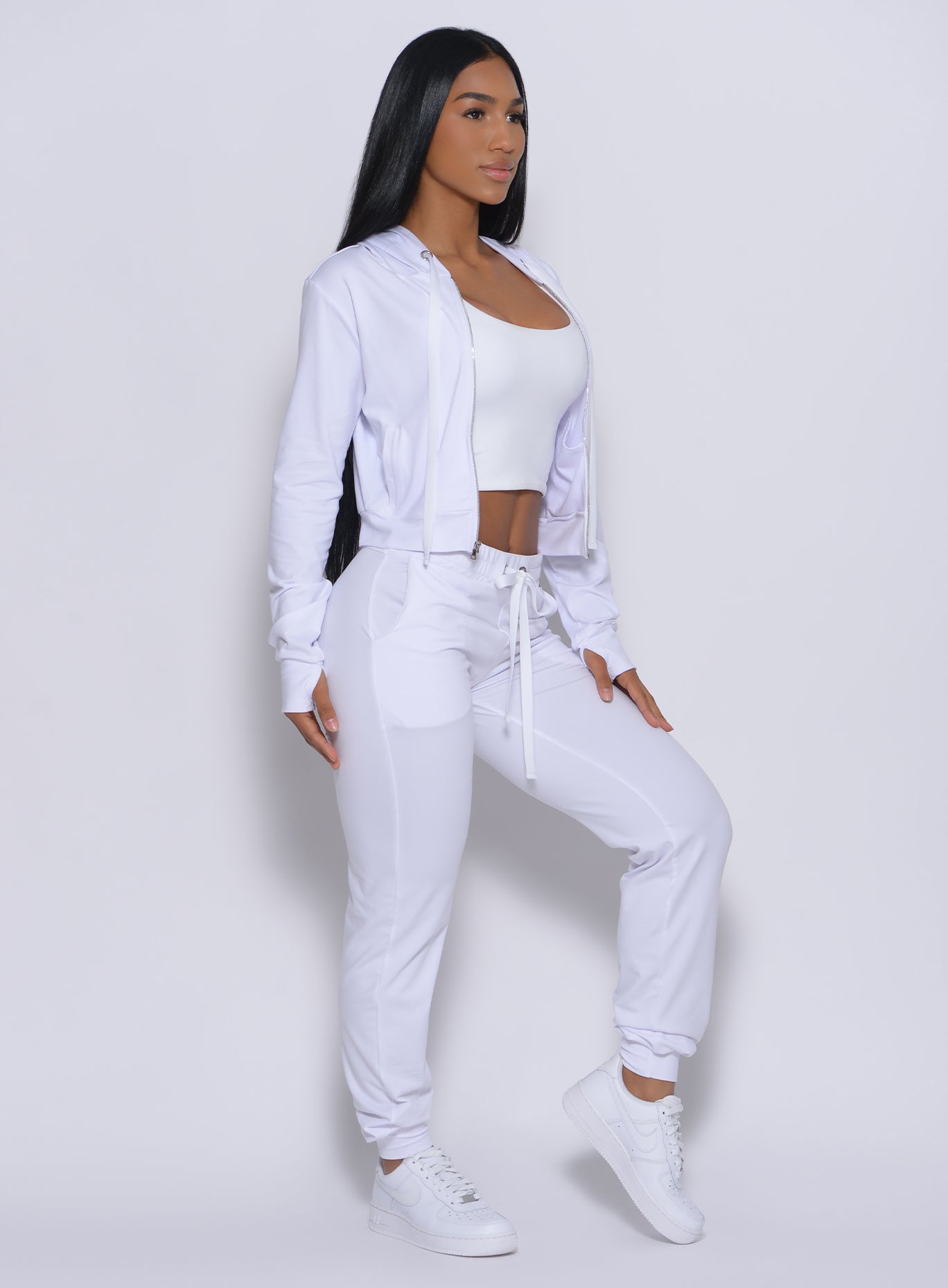 Right profile view of a model in our white signature jacket and a matching joggers