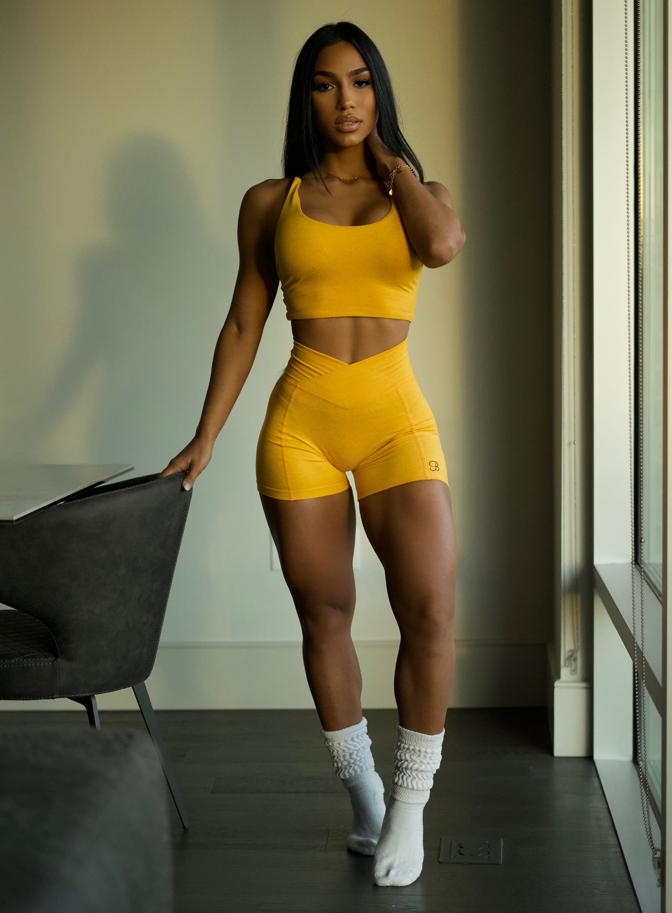 Sculpting Tiny Waist Shorts in Sunkissed; high-rise V-waistband for a snatched gym silhouette.