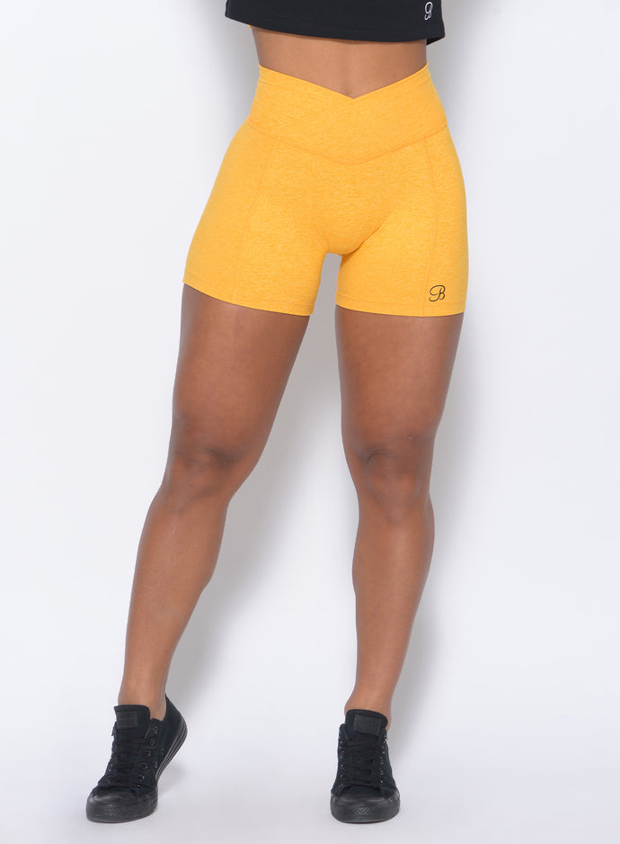 Zoomed in view of the model in our tiny waist shorts in sunkissed color