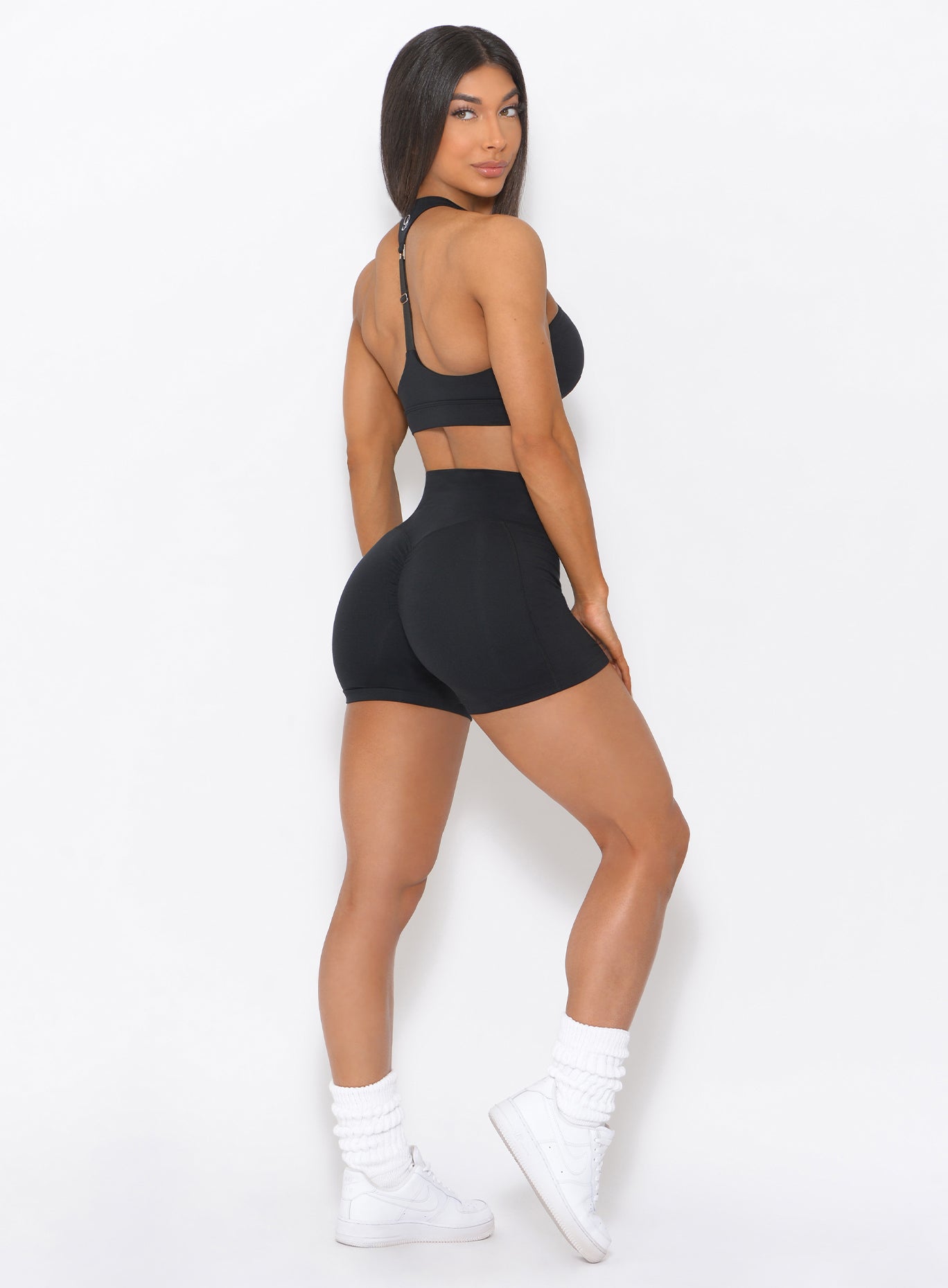 Sculpting black Tiny Waist Shorts with a V-cut waistband for a contoured gym silhouette.