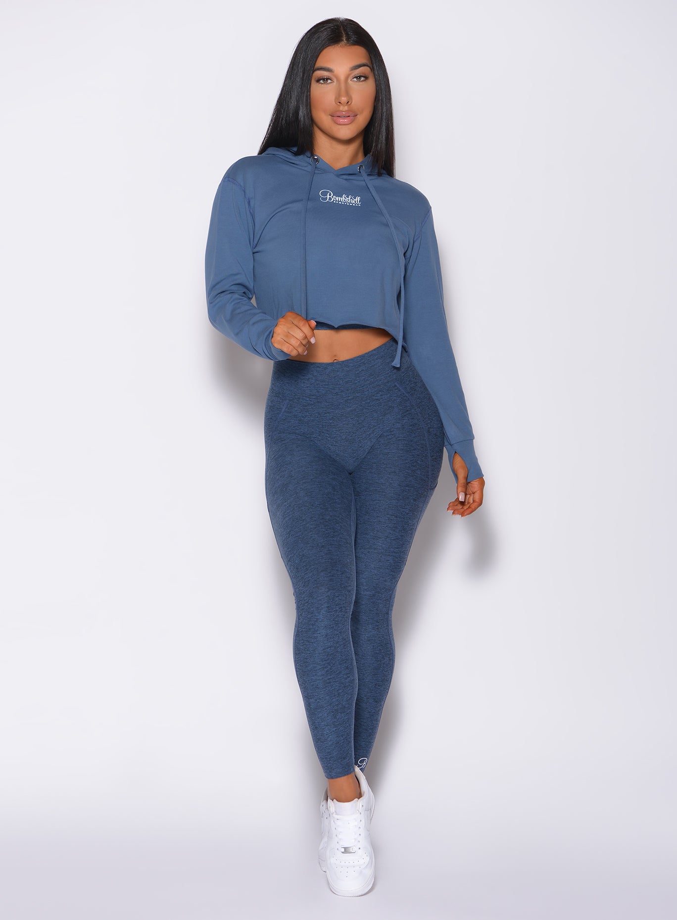 Model facing forward wearing our bombshell hoodie in blue star color and a matching leggings