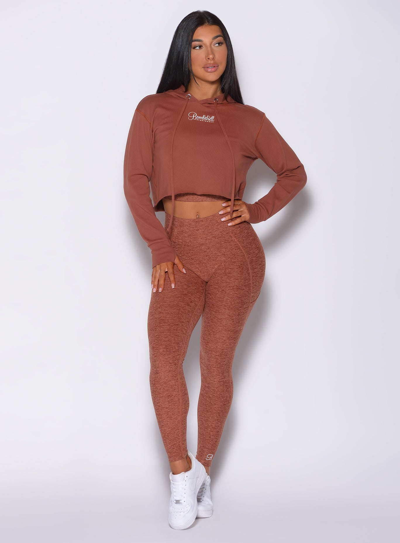 Model facing forward wearing our bombshell hoodie in caramel color and a matching leggings
