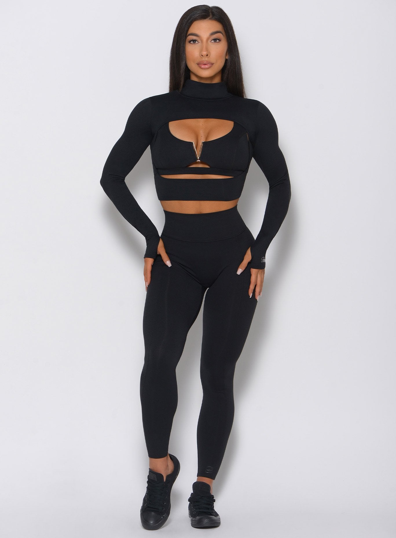 Black Combo Pullover featuring a scoop neck and thumbholes for a sleek, functional gym layer.
