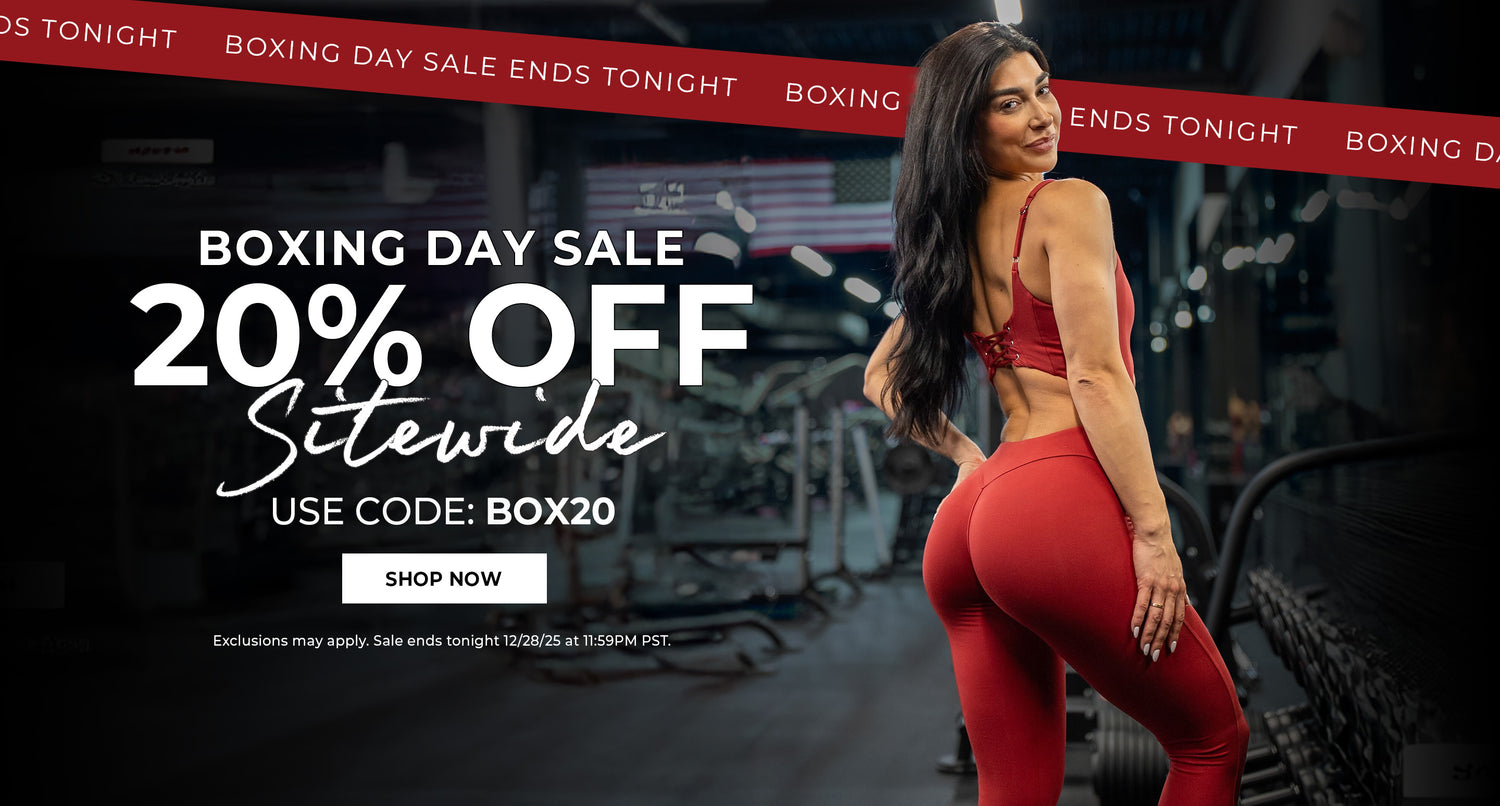 Back view of woman in Sunrise Red Sculptura Bodysuit standing in a gym with Boxing Day sale text overlay. Text in red banner says "BOXING DAY SALE ENDS TONIGHT" and white text below reads "BOXING DAY SALE 20% OFF SITEWIDE. USE CODE: BOX20" CALL TO ACTION IN WHITE BOX WITH BLACK LETTERS SAYS "SHOP NOW" below says "exclusions may apply. sale ends tonight 12/28/25 at 11:59pm PST."