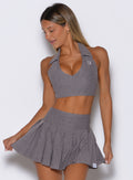 front view of a model wearing the Ace Active Top in Champion Gray color paired with the matching champion skort