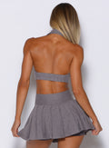 back profile view of a model wearing the Ace Active Top in Champion Gray color paired with the matching champion skort