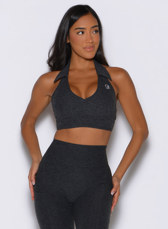front view of a model looking to the left side wearing the Ace Active Top in Charcoal color