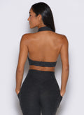 back side view of a model facing to the left side wearing the Ace Active Top in Charcoal color