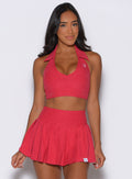 model captured from the front wearing the Ace Active Top in Victory Ruby color