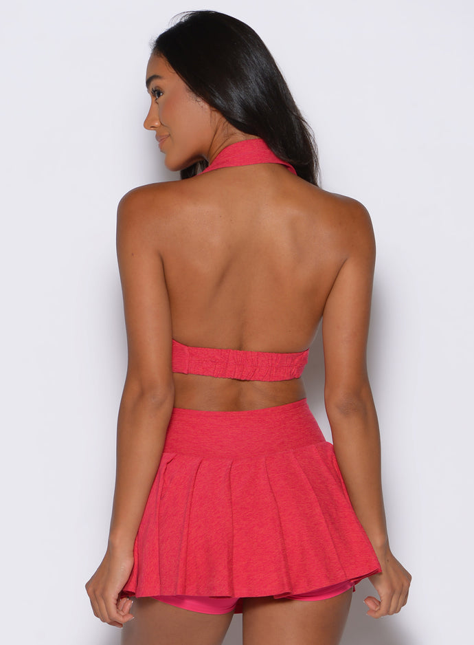back profile shot of a model wearing the Ace Active Top in Victory Ruby color paired with the matching champion skort 