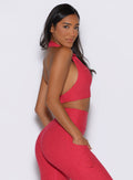 right side view of a model wearing the Ace Active Top in Victory Ruby color
