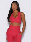 front view of a model looking to the right side wearing the Ace Active Top in Victory Ruby color