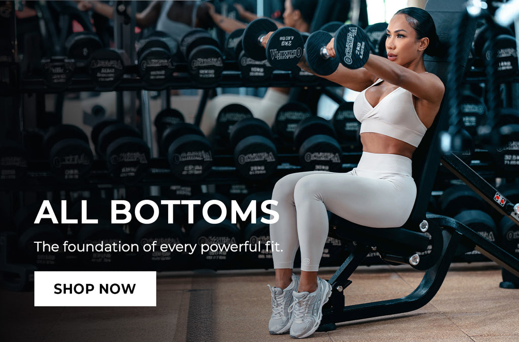 Woman exercising with dumbbells in a gym setting, Text overlay that reads: 'ALL BOTTOMS The foundation of every powerful fit.' CTA button: 'SHOP NOW'