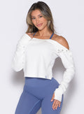 front profile view of a model with one hand on her thigh wearing the Allure Pullover in White color