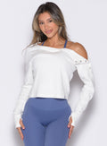 front profile view of a model with both hands on her thighs wearing the Allure Pullover in White color