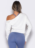 back profile view of a model with both hands on her thighs wearing the Allure Pullover in White color