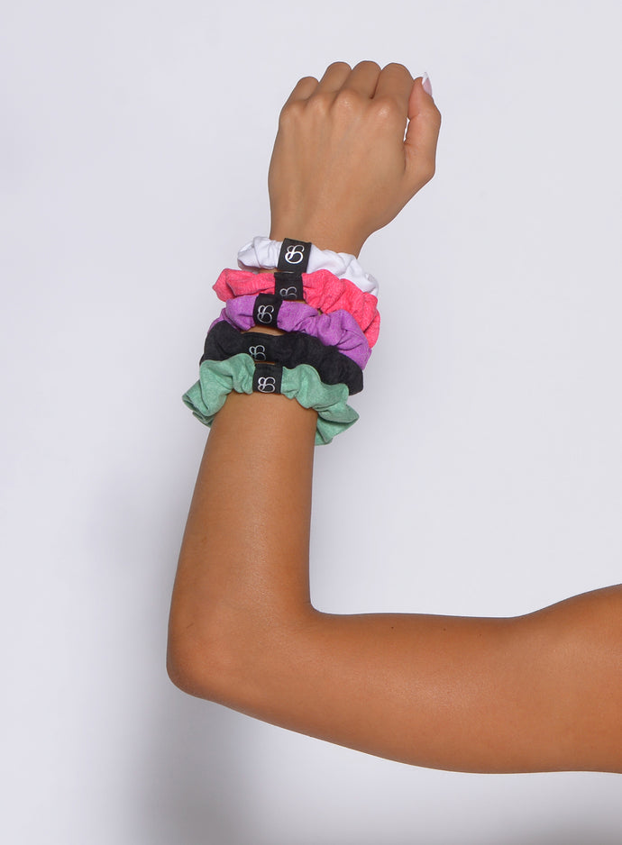 arm of a model with the B Scrunchie in sage color on the wrist