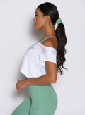 left side view of a model wearing the B Scrunchie in sage color