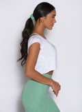 right side view of a model wearing the B Scrunchie in sage color