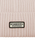 close up shot of the Bombshell Sportswear logo on the B Beanie in cream color