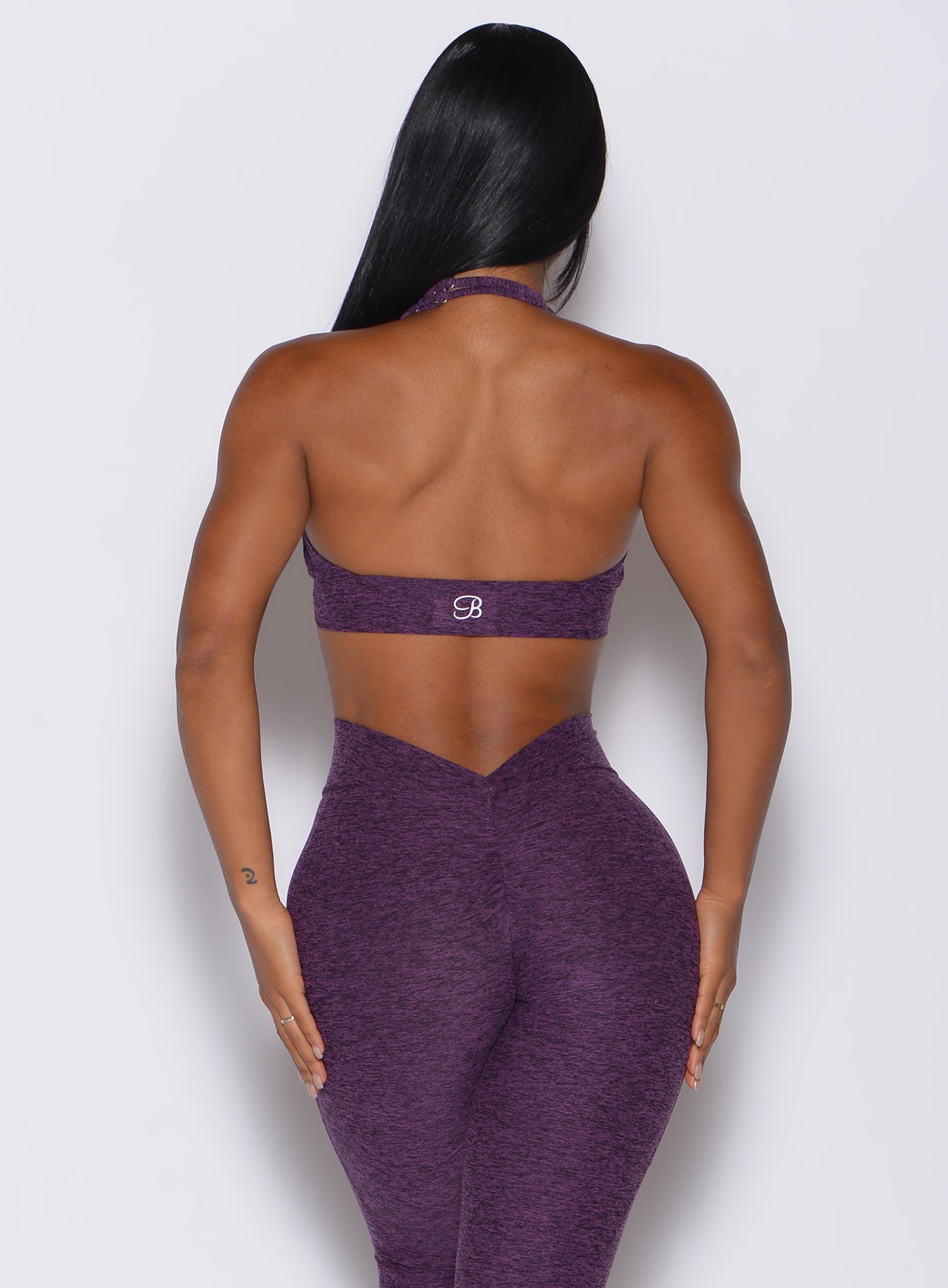 back profile view of a model  in our backless bra in Purple Passion color and the matching leggings 