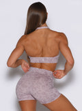 Back profile view of the model wearing the Backless Bra in Leopard Violet Ice