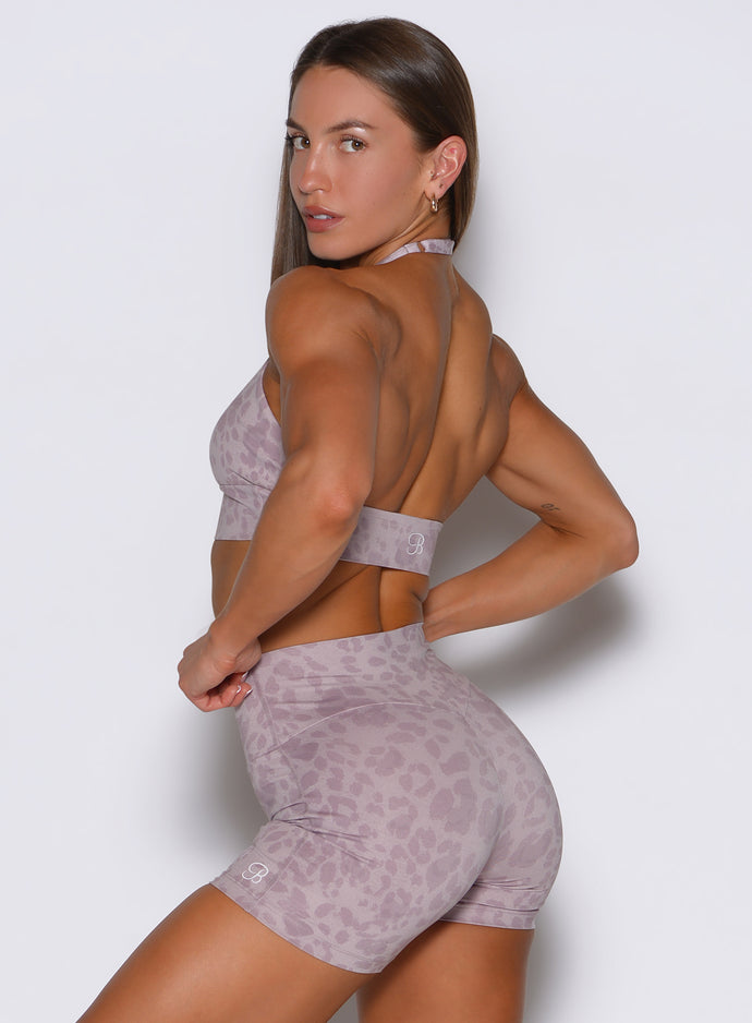 Left side profile view of the model wearing the Backless Bra in Leopard Violet Ice.