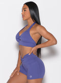 left side profile view of a model with her left hand on her waist wearing the Backless Knot Bra in future dusk color