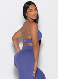 right side profile view of a model looking over her shoulder wearing the Backless Knot Bra in future dusk color