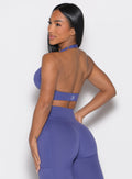 back left side profile view of a model wearing the Backless Knot Bra in future dusk color paired with the matching leggings 
