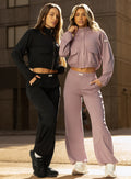 front view of models in outdoors wearing the Society Joggers in light mauve and black color paired with the matching jackets 