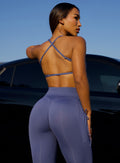 Back profile view of a model wearing the FitBoost Bra in blue slate color