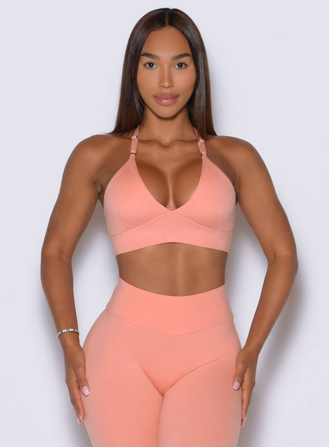 Vibrant Coral Peach brings a feminine finish to this sleek, workout-ready sports bra