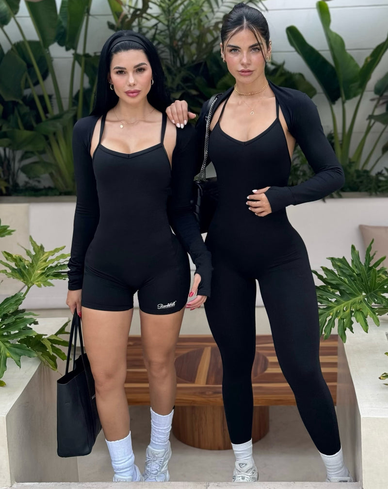 front view of two females outside facing forward wearing black Bombshell bodysuits
