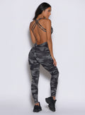 back profile view of a model facing to the right side wearing the Bombshell Bodysuit in Gray/Black camo color