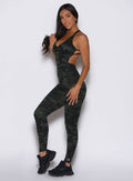 left side profile view of a model wearing the Bombshell Bodysuit in Green/Black camo color