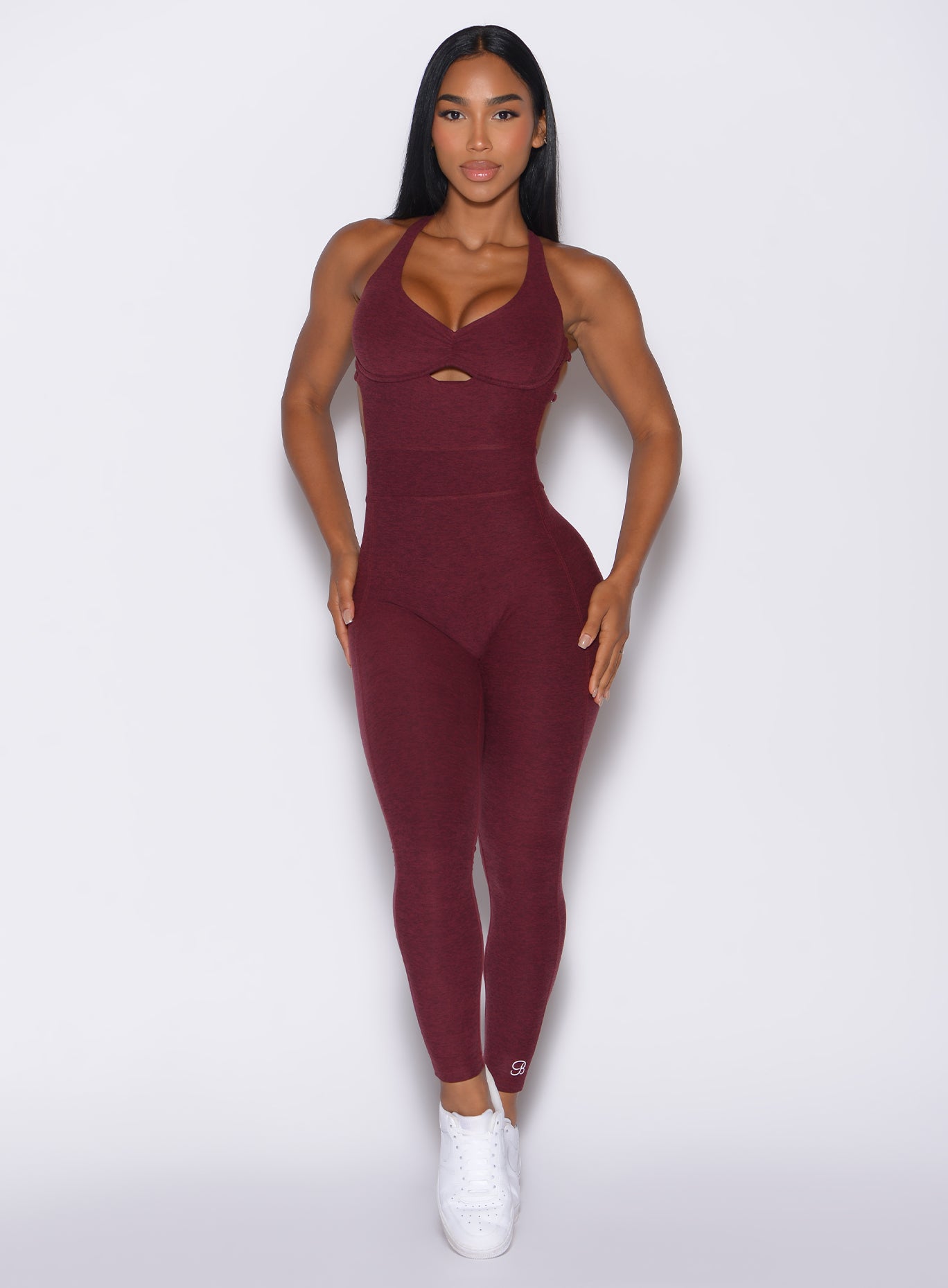 front profile view of a model in our bombshell bodysuit in red wine color 
