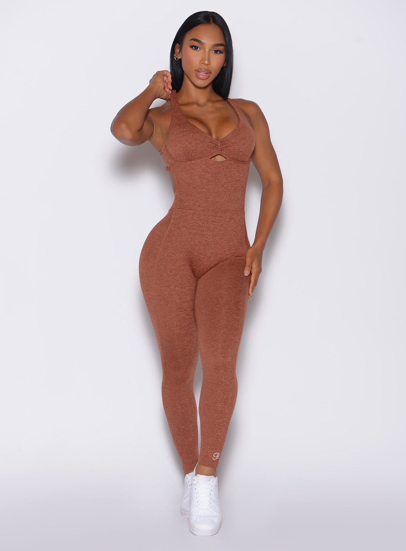 Front profile view of a model in our bombshell bodysuit in spiced chai color