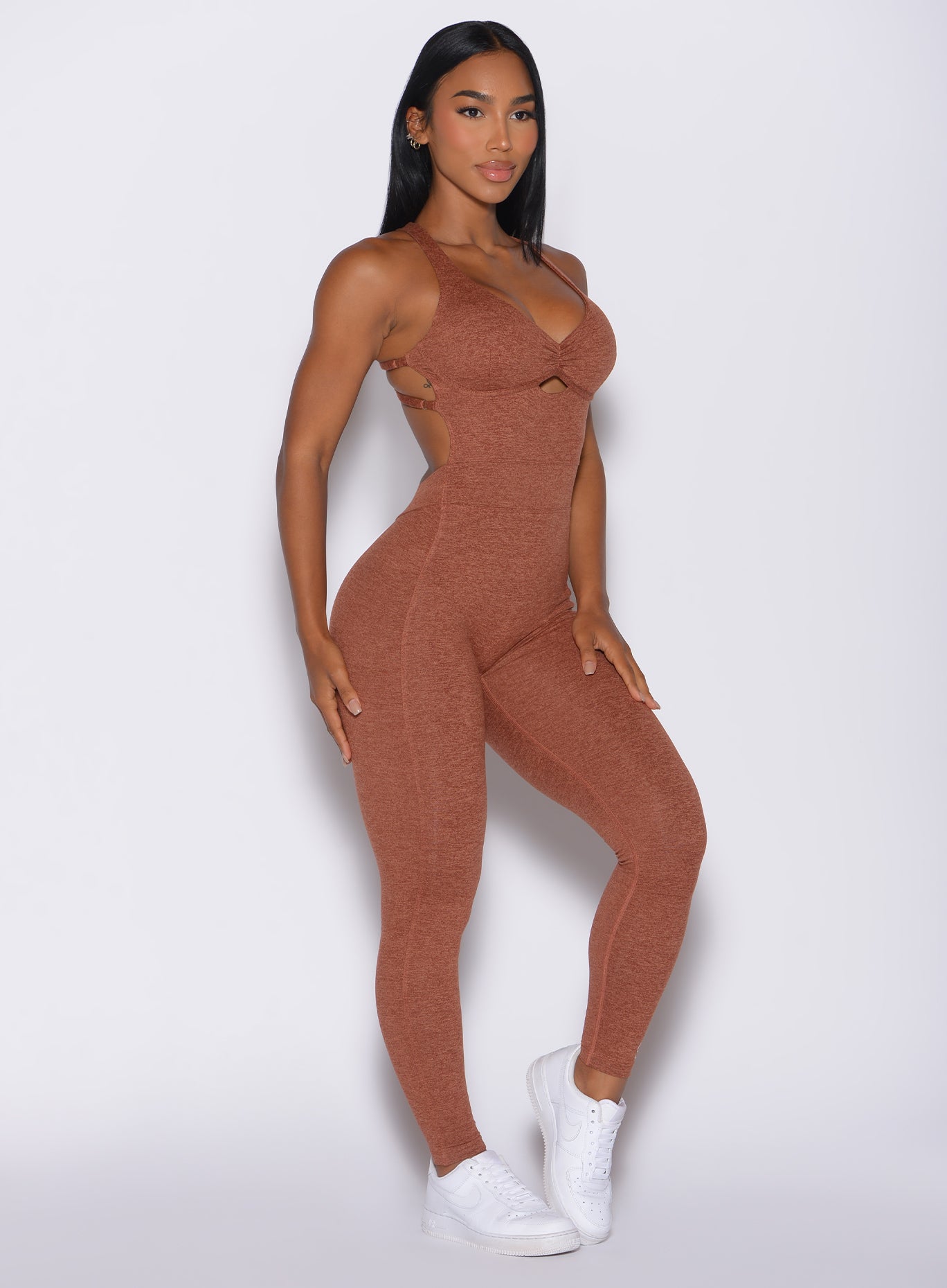Right side profile view of a model in our bombshell bodysuit in spiced chai color