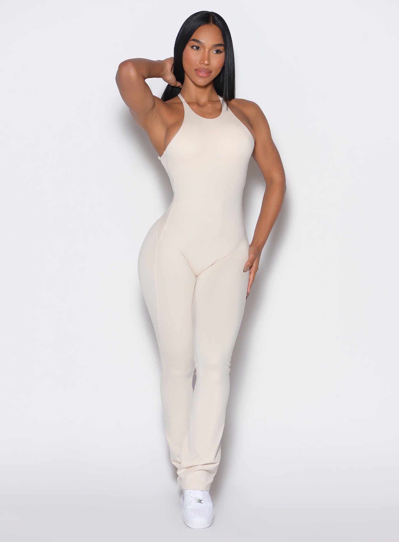 front profile view of a model wearing our bombshell bunny bodysuit in Almond Milk color