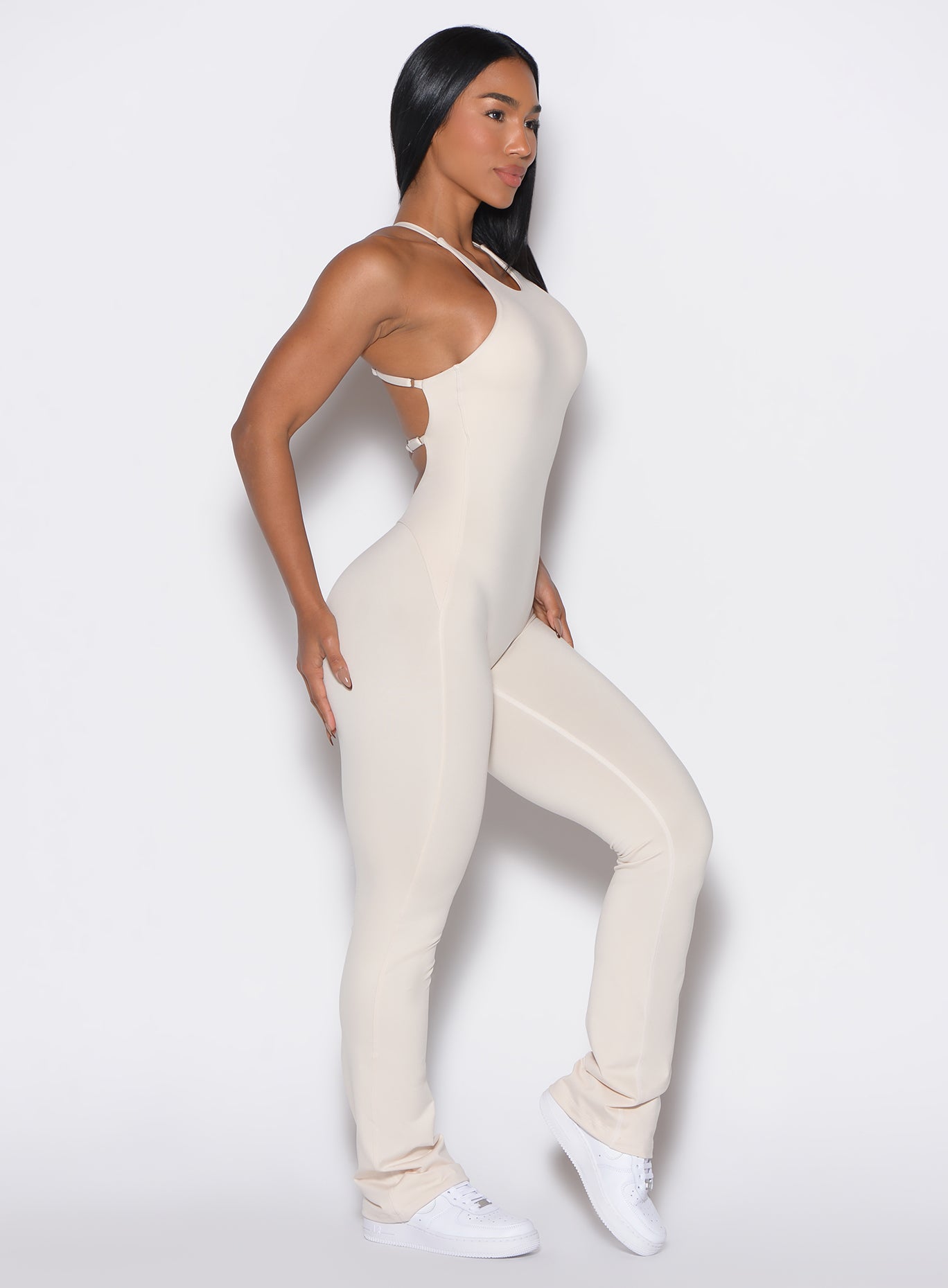 right side profile view of a model wearing our bombshell bunny bodysuit in Almond Milk color