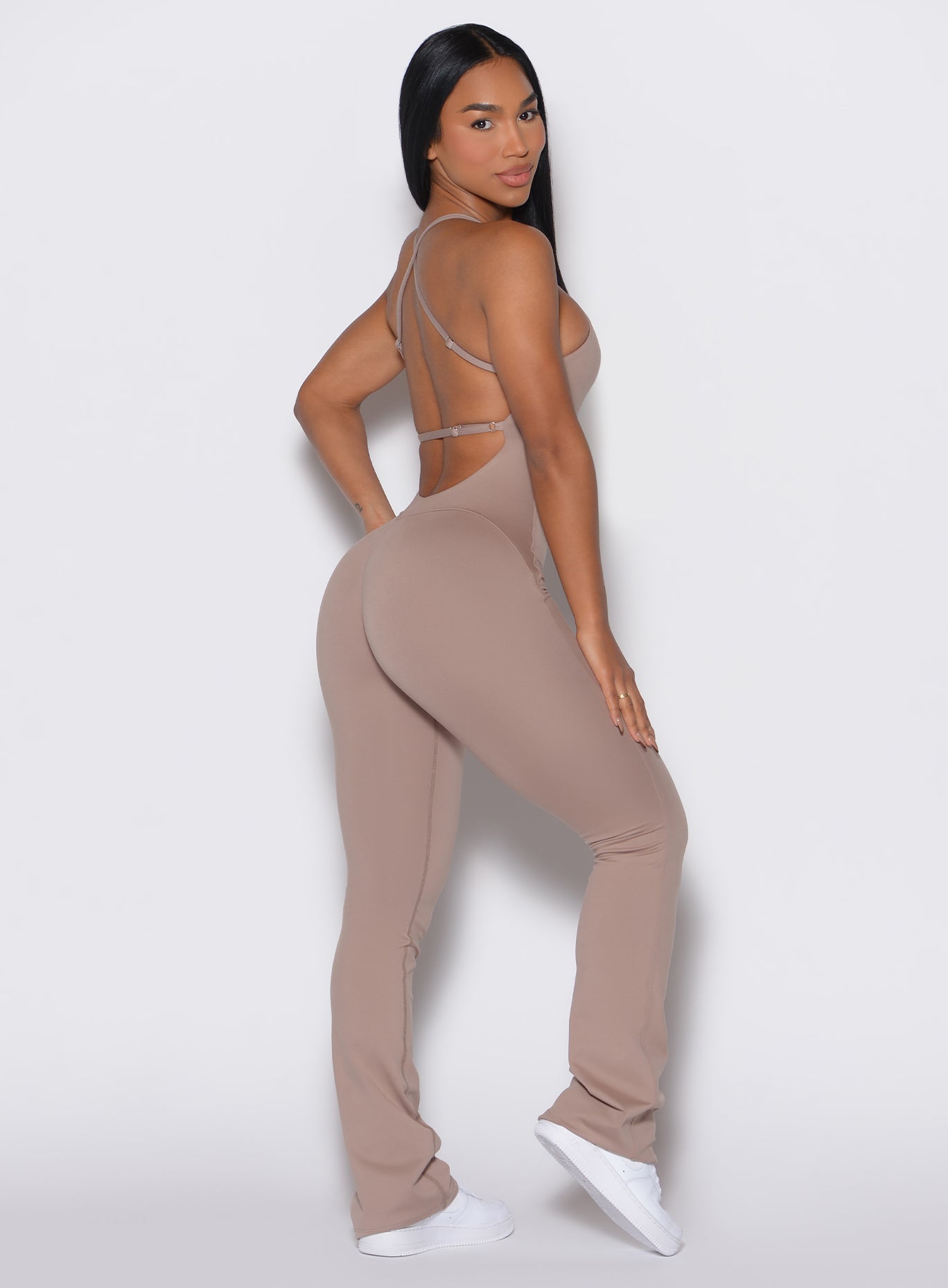 Right profile view of a model wearing the Bombshell Bunny Bodysuit in Clay color.