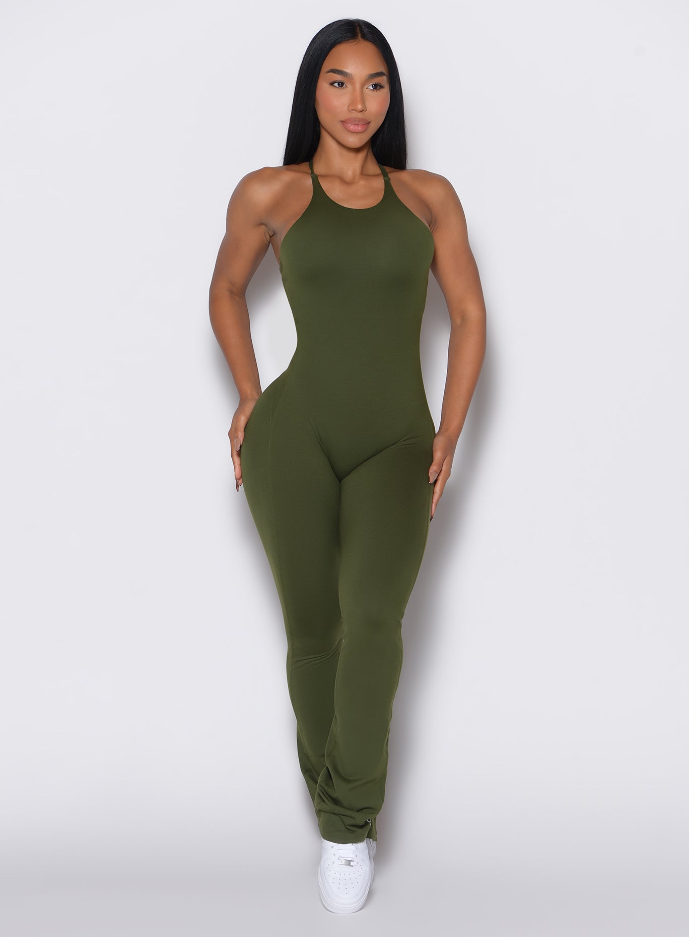 Front profile view of a model wearing the Bombshell Bunny Bodysuit in Jungle color