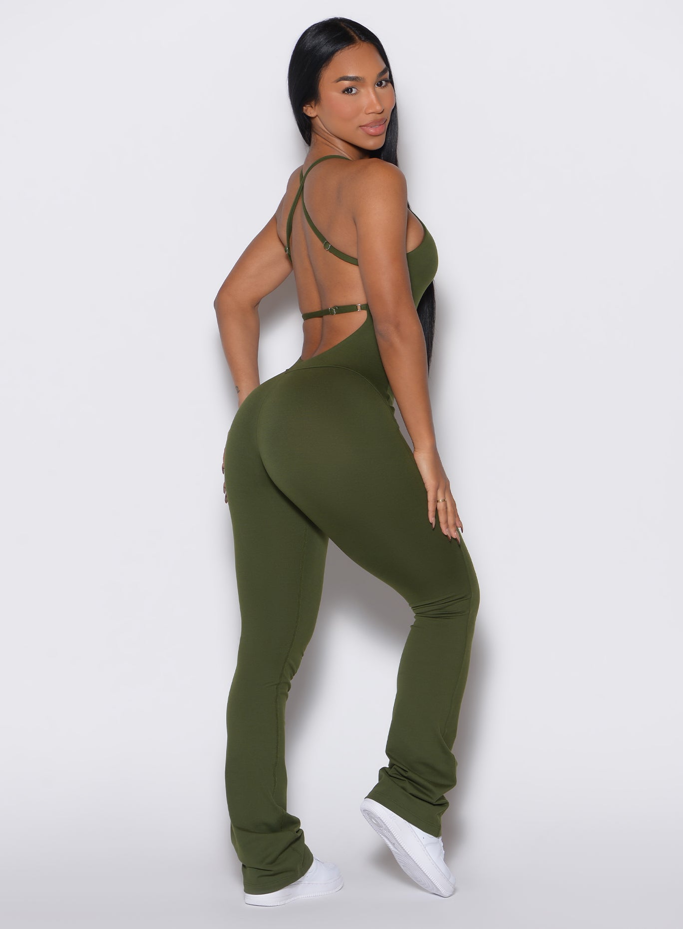 Right side profile view of a model wearing the Bombshell Bunny Bodysuit in Jungle color