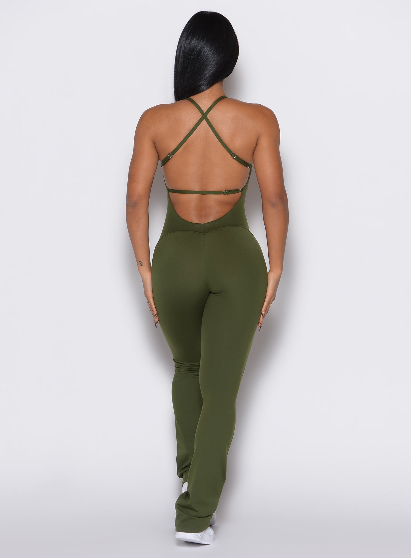 Back profile view of a model wearing the Bombshell Bunny Bodysuit in Jungle color