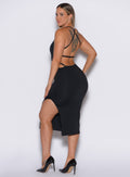 left side  profile picture of a model facing to her left wearing our black bombshell bunny dress
