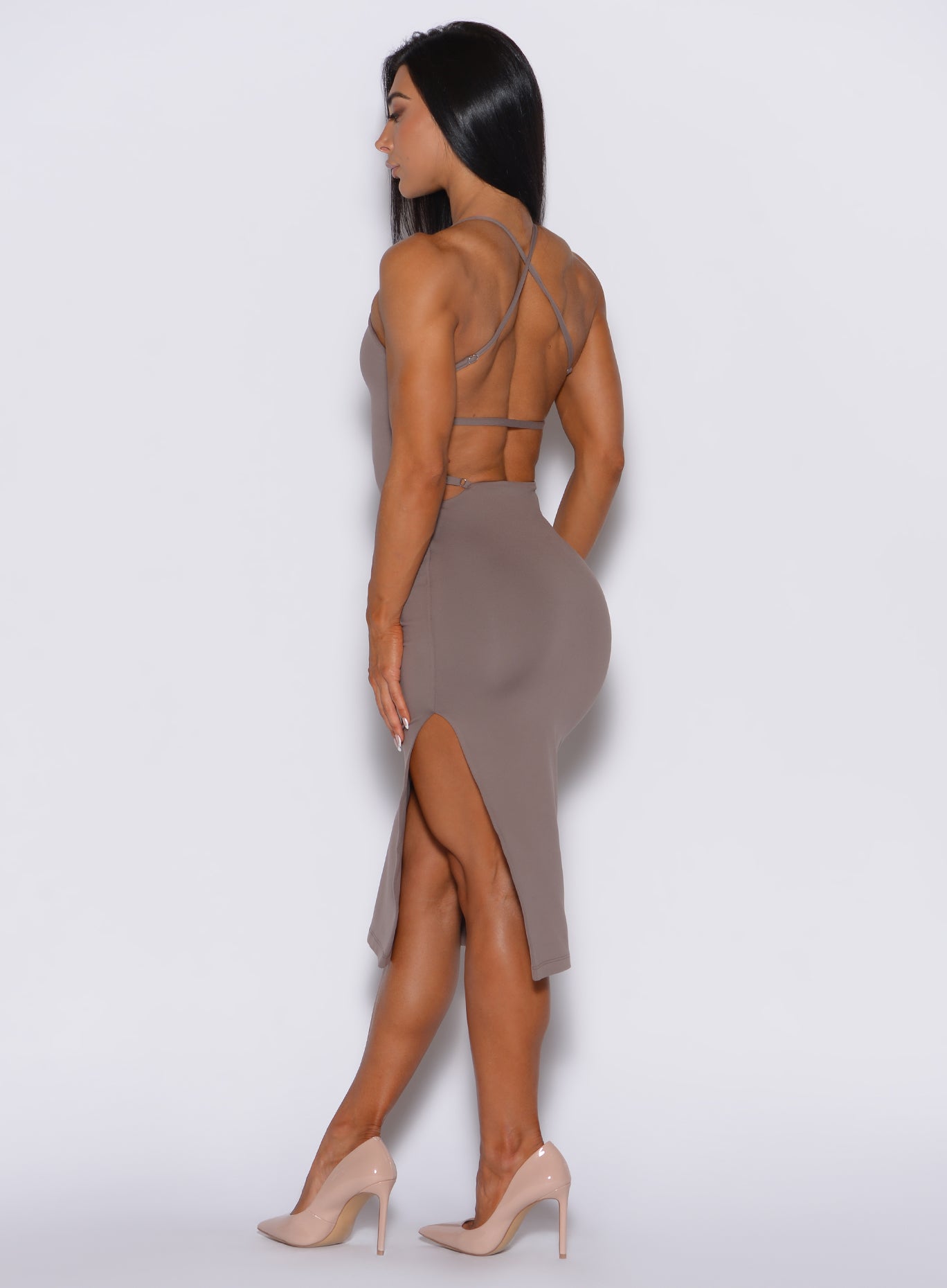 left side side profile picture of a model angled slightly to her right wearing our bombshell bunny dress in espresso color
